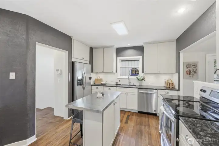 The updated kitchen is a nod to homeowner preferences, with popular features such as a new dishwasher, countertops, and a stainless steel topped island.