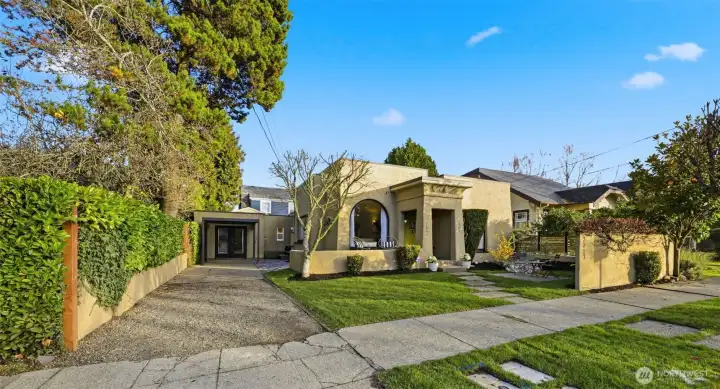 Here you can observe the driveway along the side of the home… your tandem parking spaces. The primary suite was a garage several years ago. A carport could easily be added.