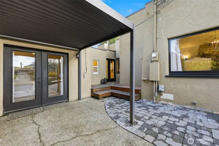 The overhead cover can be adjusted to allow for sunlight, or to protect against the rain. The door seen at top of the deck leads into the hallway outside the kitchen.