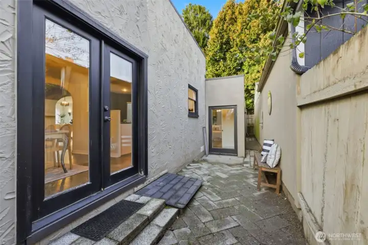 The door seen in the middle of this photo is just outside the primary suite. The long narrow space to the right of this door provides a perfect place to set up a ladder and access the roof.