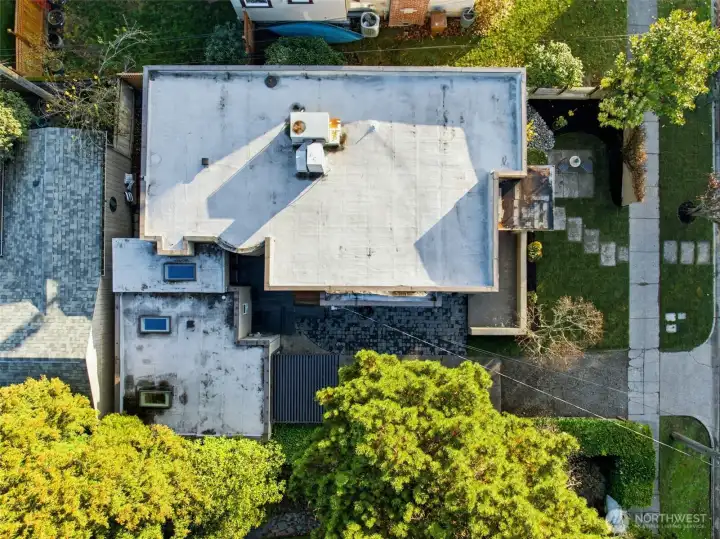 This aerial view shows how the primary suite on the left connects to the original home. You can see where three skylights were added.