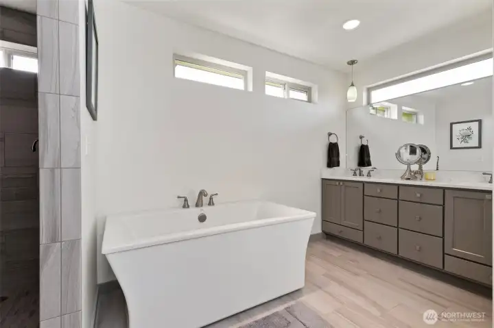 Primary en-suite bathroom with soaking tub, double vanities and curbless shower.