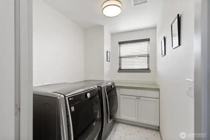 Upstairs laundry with storage.
