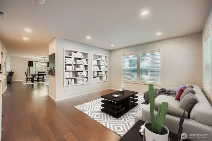 Front living room at entrance with built in shelving. (Virtually Staged)