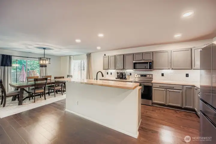 Kitchen area opening to dining area and living space