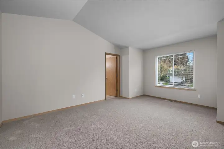 Vaulted ceilings in primary bedroom adds an extra nice touch