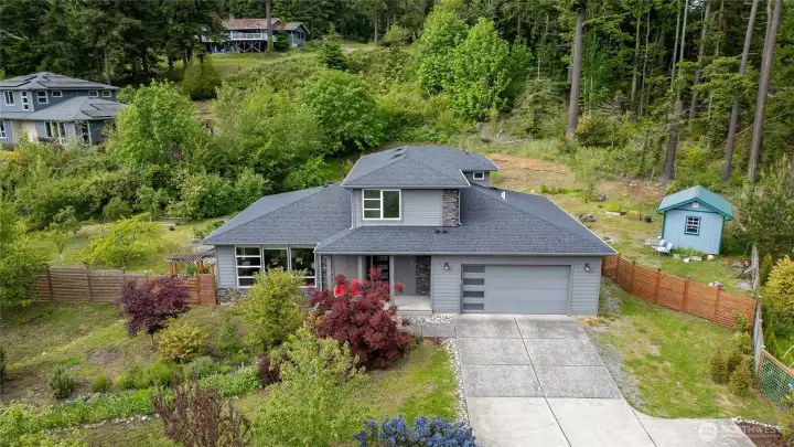 This modern home sits on a nearly half-acre lot, surrounded by a variety of gardens.
