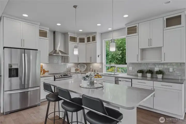New appliances include refrigerator with bottom freezer and induction stove.
