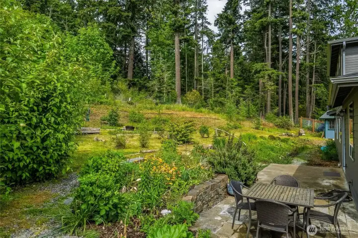 Large patio off the kitchen's sliding door provides lots of space to enjoy the gardens. Plus, there's a gas hookup for the barbecue.