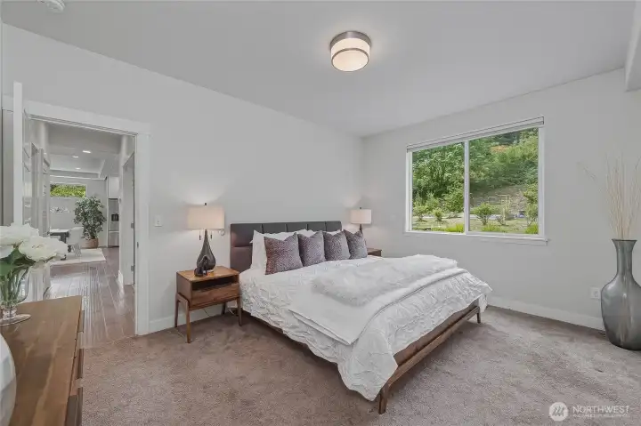 On the main floor is the primary suite, with large window onto the back yard.