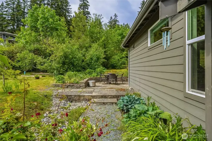 Going through the garden gate, leads you straight ahead to the back patio, and to the left is a mini orchard.