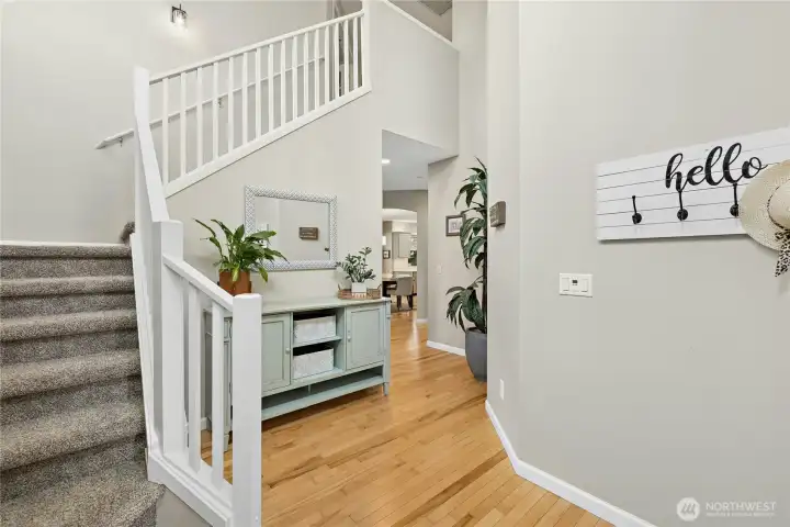 Generous entryway with vaulted ceiling…notice the natural maple wood floors