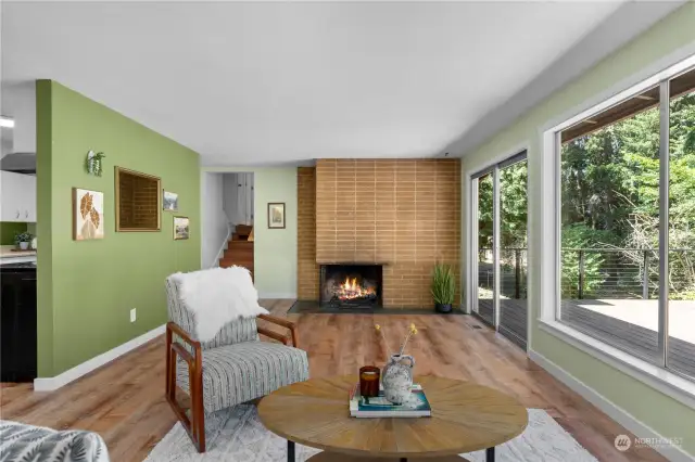 Bright and airy living room with large windows and a cozy fireplace.