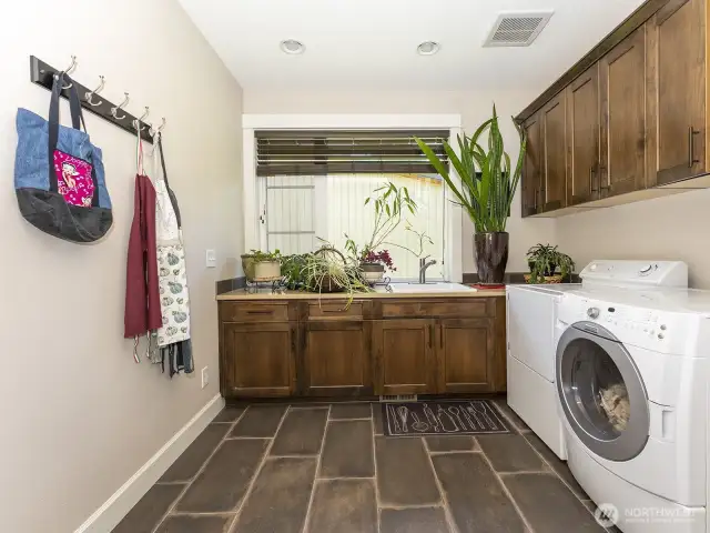 Laundry Room with Storage Cabinets and Washer and Dryer