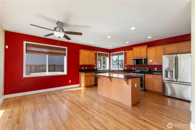 This beautifully designed kitchen features granite countertops and matching backsplash, pantry, and an abundance of cabinet and counter space. Enjoy cooking with stainless steel appliances, including a gas range and brand-new microwave. The center island with breakfast bar is perfect for casual meals, and a separate eating area offers even more space to gather.