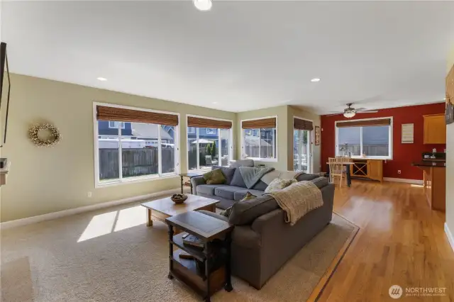 The home features an open floor plan with window coverings, heat pump to keep the home a comfortable temperature year-round, and hardwood floor in the kitchen, separate eating area, entry and hall.