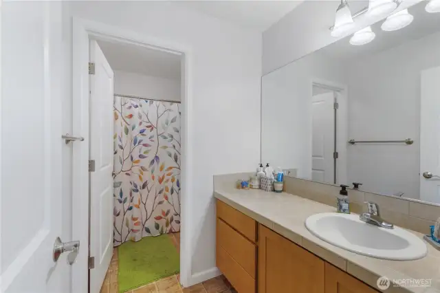 Designed with function in mind, the main bathroom features a separate toilet and tub/shower room for added privacy and ease. Generous cabinet and counter space make busy mornings a breeze.