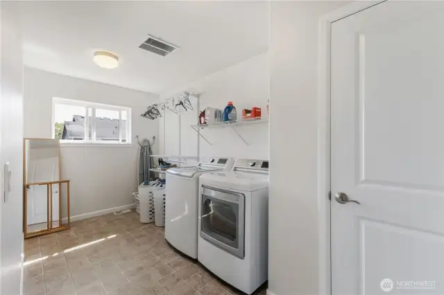 The upstairs utility room features a large linen closet, extra shelving, plumbed for a utility sink and ability to have more than one dryer!
