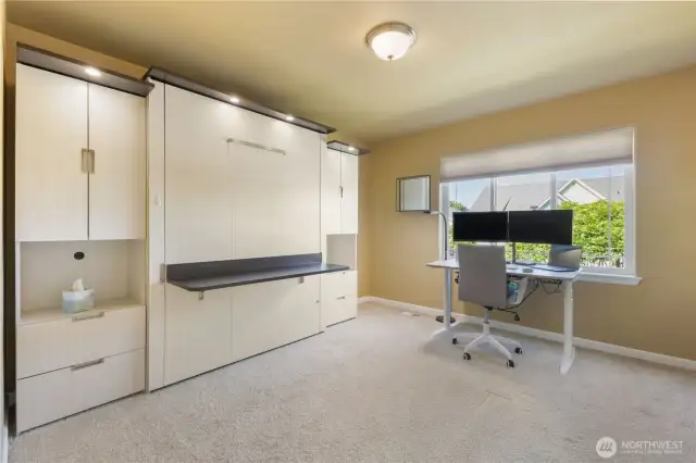 The fourth bedroom offers flexibility with a built-in Murphy bed—perfect for guests or a home office setup. A large closet provides ample storage, while built-in display shelves add both function and charm.