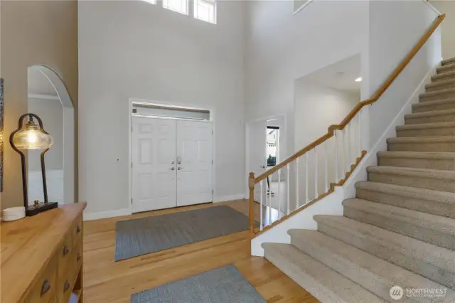 Impressive entry featuring French doors with keyless entry, soaring ceilings, rich wood floors, and open banister stairs. A spacious, deep closet offers bonus wine storage potential. Additional features of the home are a built-in speaker systerm, security system, cameras and more!