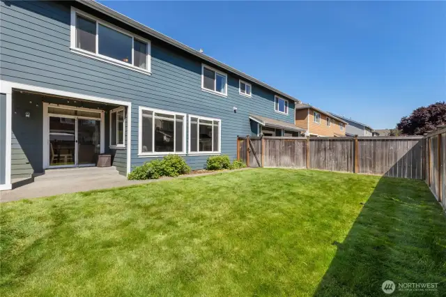 View of the back of the home and the covered patio.