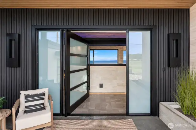 The glass door pivots in and opens to high-end luxury living.