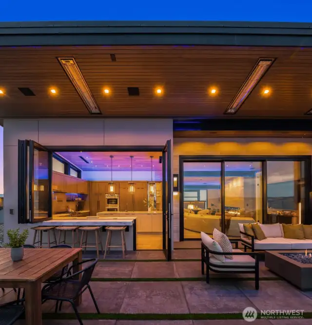 Seating is at the open bar, or the outdoor gas fireplace. You will be cozy warm with the built in heaters above in the soffits.