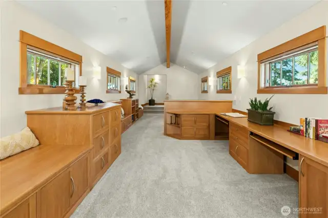 Natural light pours into this Loft / Office space providing 2 built-in desks, built-in file cabinets, multiple reading nooks / benches, and plenty of bookcases.