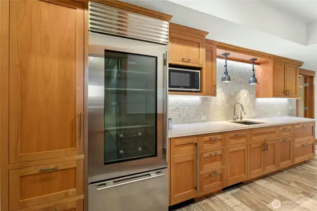 Wet bar on Lower-Level offers undercabinet spectrum lighting (choose your mood), Sub-zero Refrigerator, Microwave, Cabinet-faced Dishwasher & Cabinet-faced Ice Maker.