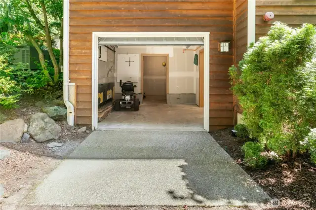 Additional storage / workshop space with a garage door providing easy access to the outside and plenty of ventilation as needed. Inside workshop (to the right in this picture) includes Built in Storage, Workbench, and Peg Board Storage.