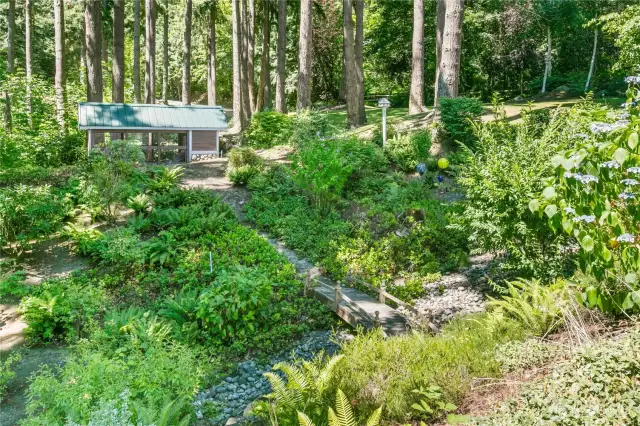 Pathway over bridge to covered dog kennel (maybe chicken coop?).