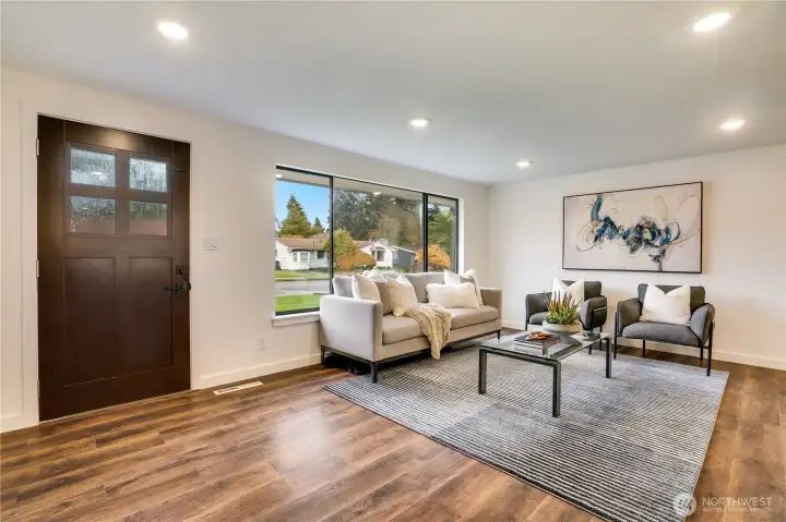 A striking new entry door welcomes you, flowing seamlessly into durable, stylish LVP flooring throughout.