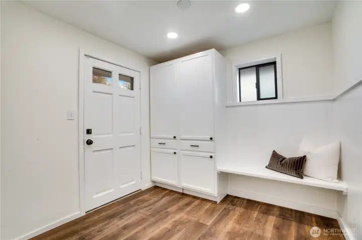Convenient mudroom/utility off the garage with built-in storage and direct backyard access—perfect for everyday ease.