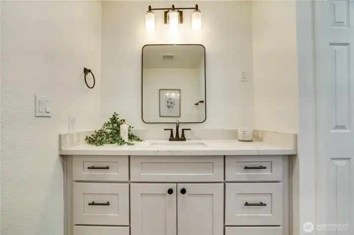 Renovated full bathroom with ample linen storage and thoughtful design.