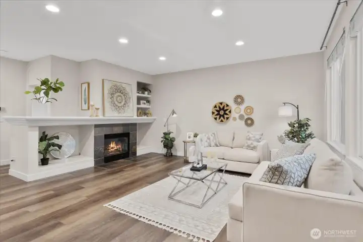 Family room features cozy gas fire and lots of natural light