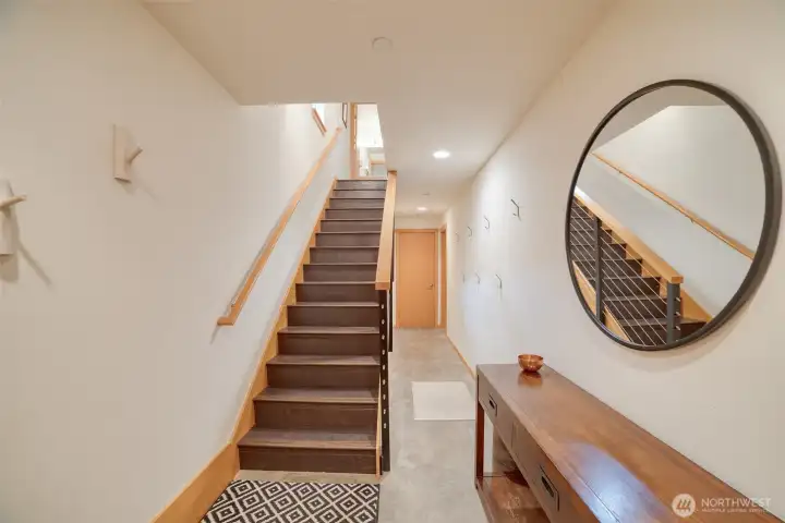 Entry leading to the lower bedroom, utility room, and access to the garage