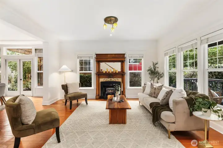 Large living room just off the entry featuring charming gas fireplace.
