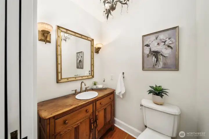 Main floor powder room with custom cabinet and beautiful fixtures.