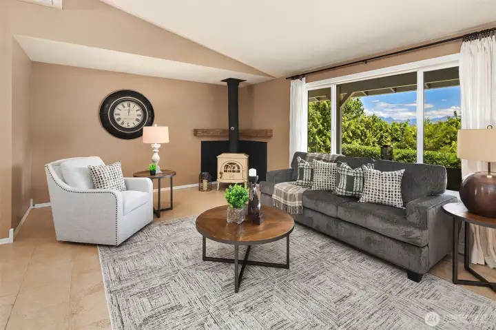 There is a wood burning stove in the living room section.