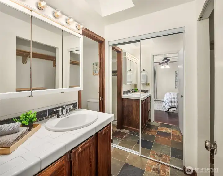 Primary bathroom with cloests.