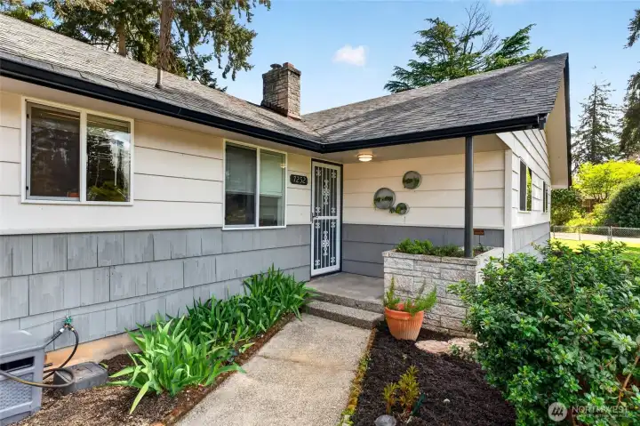 Charmng entry that offers a built-in planter box for a year-round herb garden or seasonal flowers