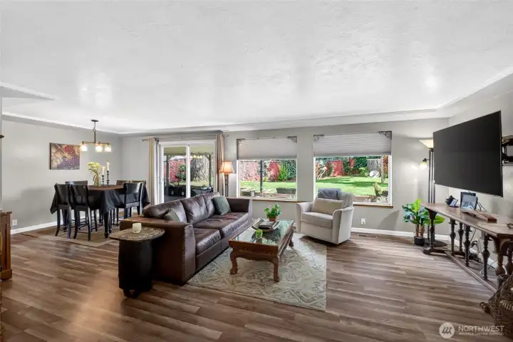 Laminate was replaced by previous owner and adds to the cohesiveness as it's throughout the main area..  Look up and see the tray ceiiling, a nice architectural touch.