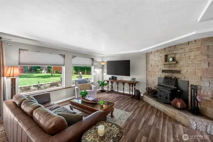 The brick fireplace is the showstopper of this room!  A wood burning insert has been added- lots of warnth and comfort on a chilly PNW evening!