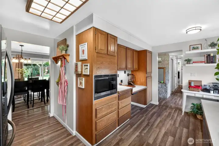 Well maintained kitchen featuring a timeless charm, stainless steel appliances, and a functional walk-through layout with a front facing window that fills the space with natural light.
