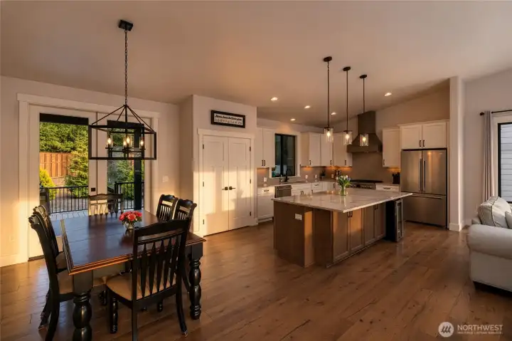 Elegant open kitchen and dining with warm natural light throughout. Elegant open kitchen and dining with warm natural light throughout.