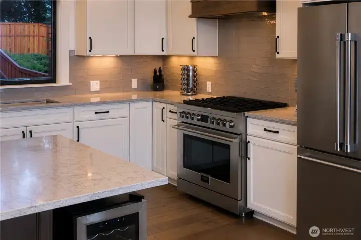 Chef-inspired kitchen with sleek finishes and premium appliances. Chef-inspired kitchen with sleek finishes and premium appliances.