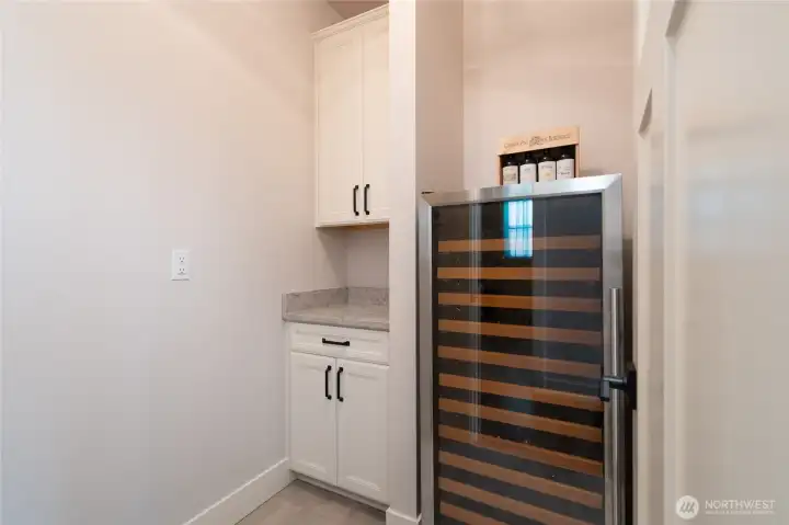 Bonus wine storage nook with built-in cabinetry and cooler. Bonus wine storage nook with built-in cabinetry and cooler.