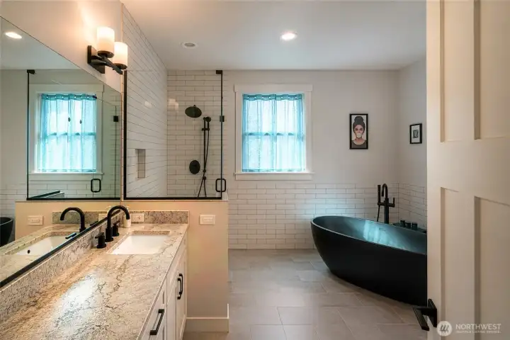 Spa-inspired primary bath with soaking tub and luxe finishes. Spa-inspired primary bath with soaking tub and luxe finishes.