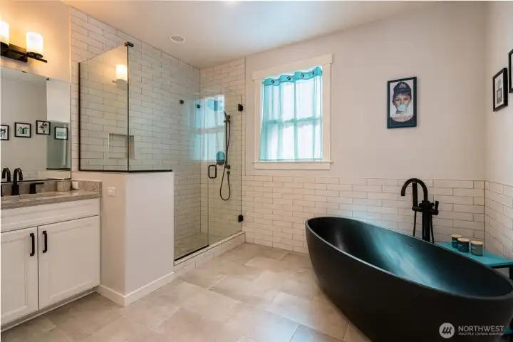 Luxury primary bath with soaking tub and walk-in glass shower. Luxury primary bath with soaking tub and walk-in glass shower.