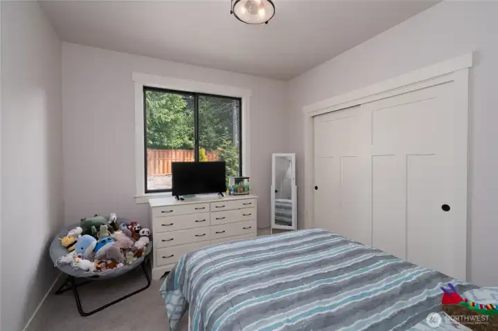 Bright and cozy bedroom with peaceful backyard views and ample storage. Bright and cozy bedroom with peaceful backyard views and ample storage.